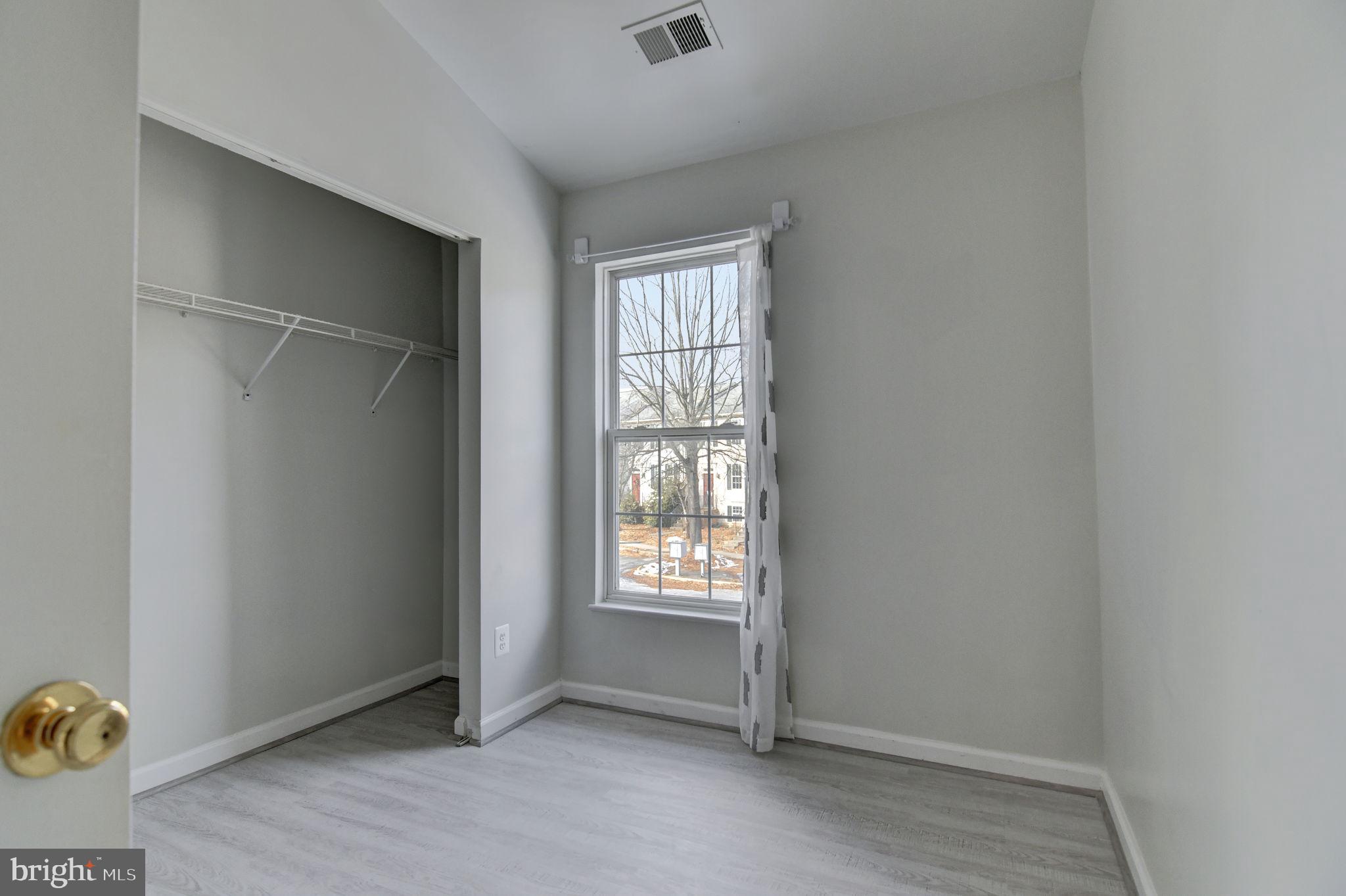 4013 Mammoth Cave Loop Dumfries, VA 22025 - Photo 22 of 38 wooden floor and window in an empty room