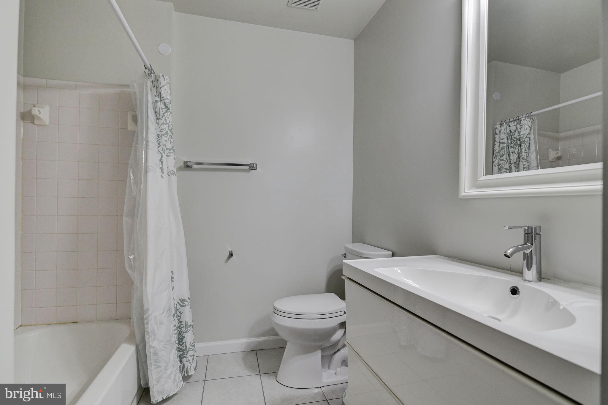 4013 Mammoth Cave Loop Dumfries, VA 22025 - Photo 27 of 38 a bathroom with a toilet sink and shower