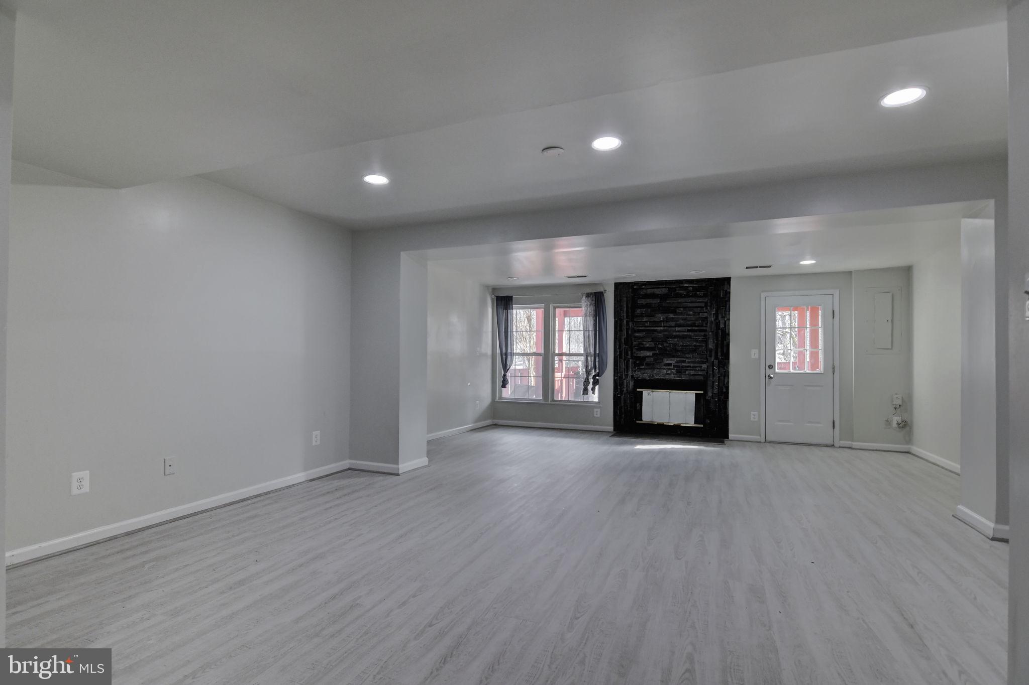 4013 Mammoth Cave Loop Dumfries, VA 22025 - Photo 29 of 38 a view of an empty room with window and wooden floor
