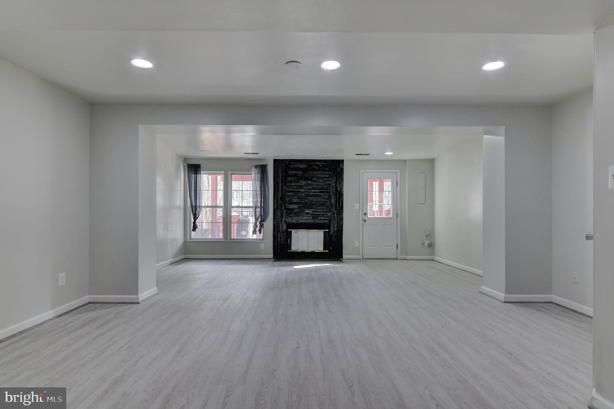 4013 Mammoth Cave Loop Dumfries, VA 22025 - Photo 30 of 38 an empty room with wooden floor and fireplace