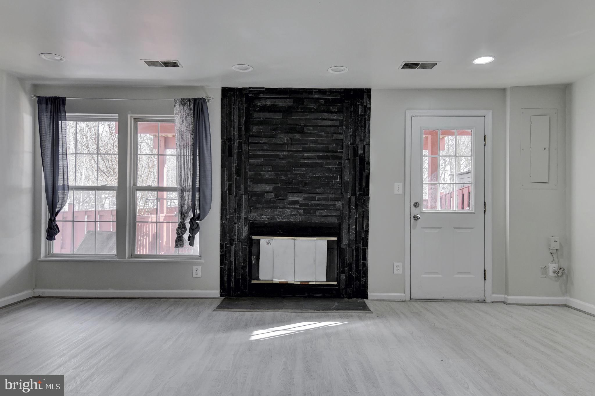 4013 Mammoth Cave Loop Dumfries, VA 22025 - Photo 32 of 38 an empty room with windows and fireplace