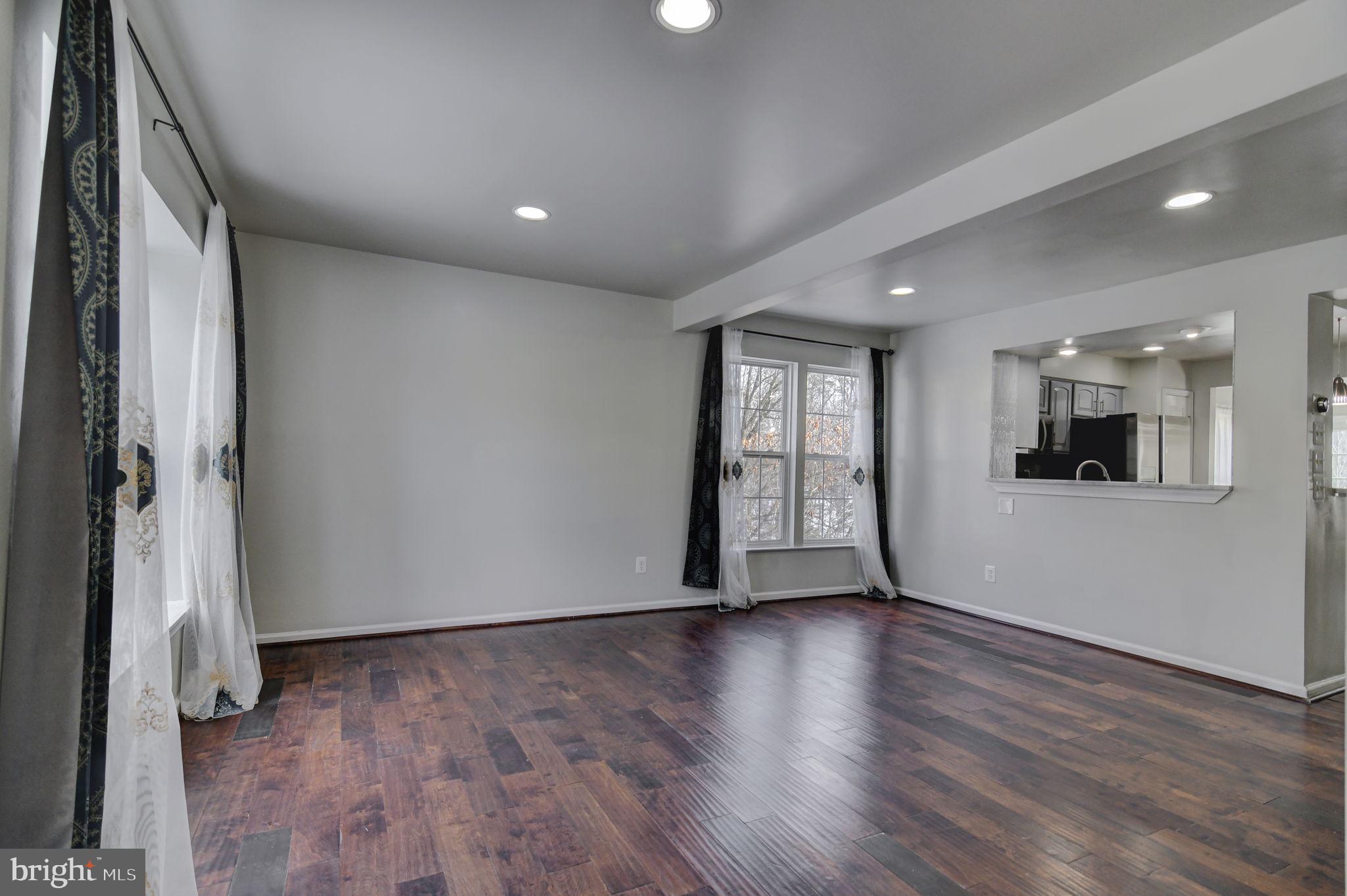 4013 Mammoth Cave Loop Dumfries, VA 22025 - Photo 5 of 38 a view of an empty room with a window and wooden floor