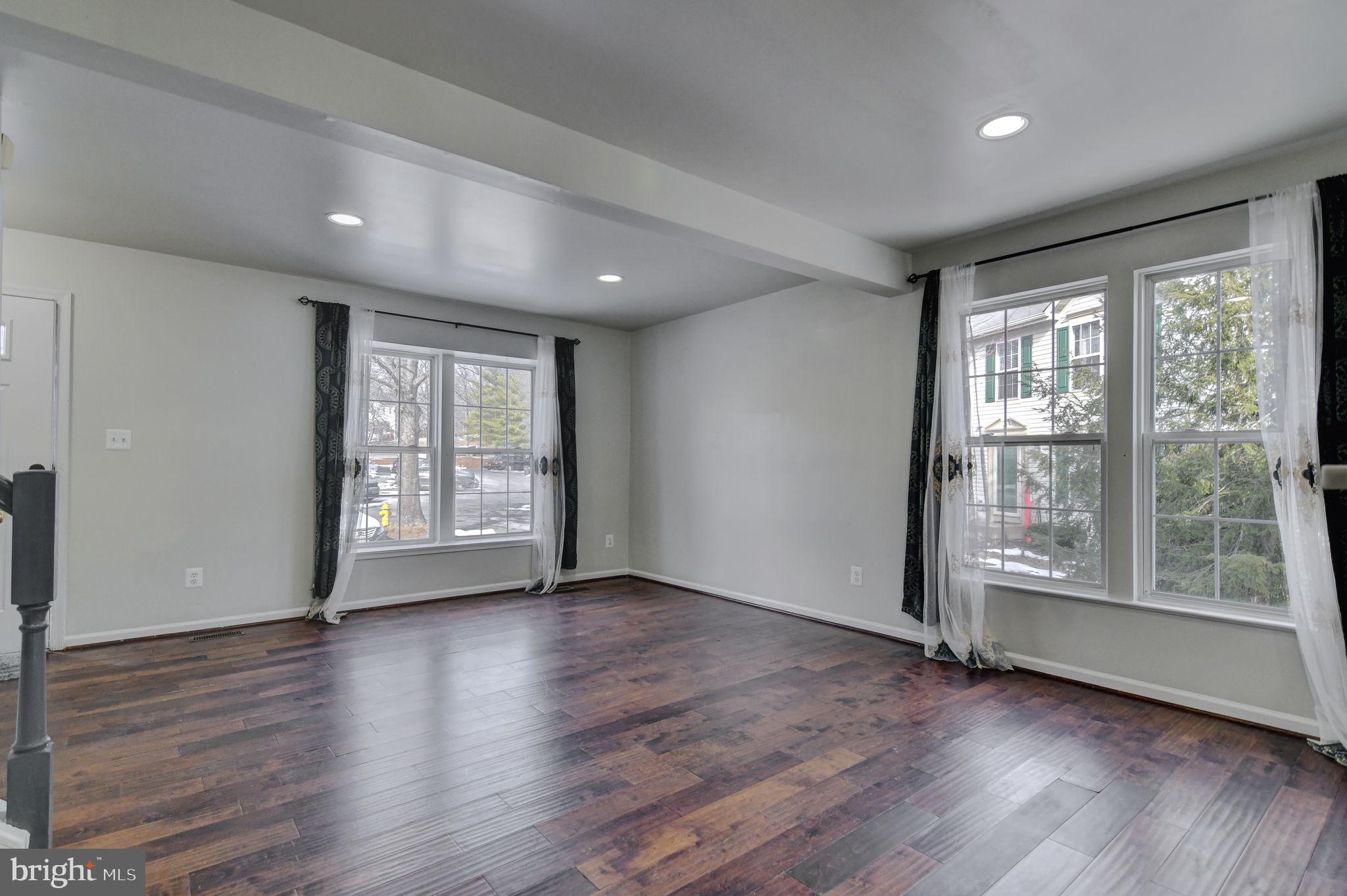4013 Mammoth Cave Loop Dumfries, VA 22025 - Photo 6 of 38 a view of an empty room with wooden floor and a window