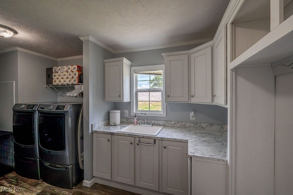 560 Wine Road Elizabeth, WV 26143 - Photo 5 of 50 Laundry room with a textured ceiling, ornamental molding, washing machine and dryer, and dark wood-type flooring