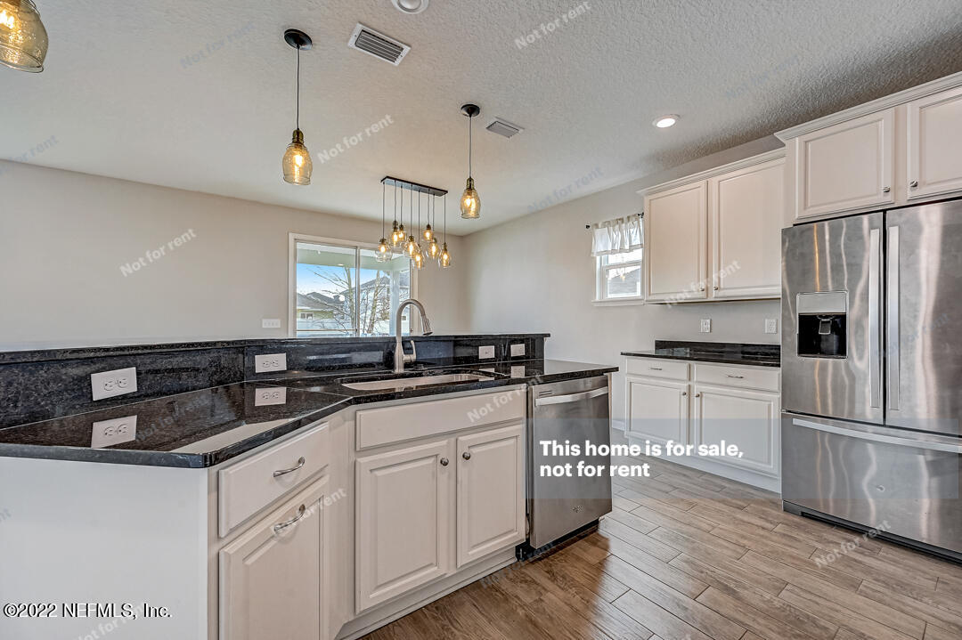 68 Redland Way Jacksonville, FL 32218 - Photo 13 of 36 a kitchen with granite countertop a sink stainless steel appliances and cabinets