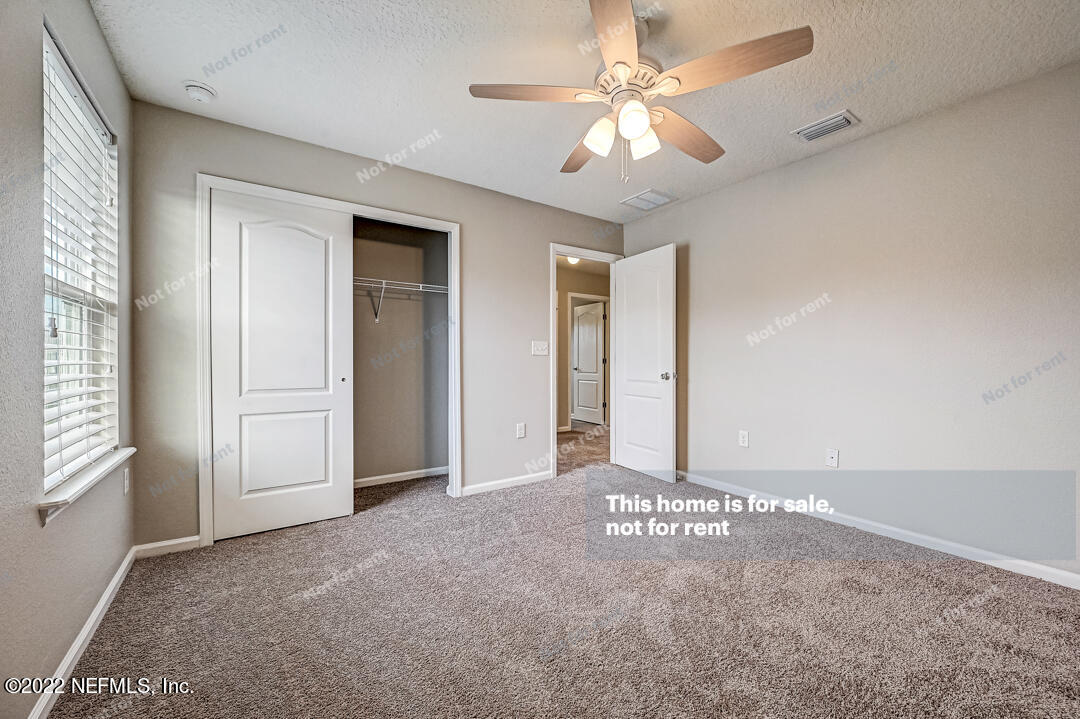 68 Redland Way Jacksonville, FL 32218 - Photo 23 of 36 en empty room with windows and ceiling fan