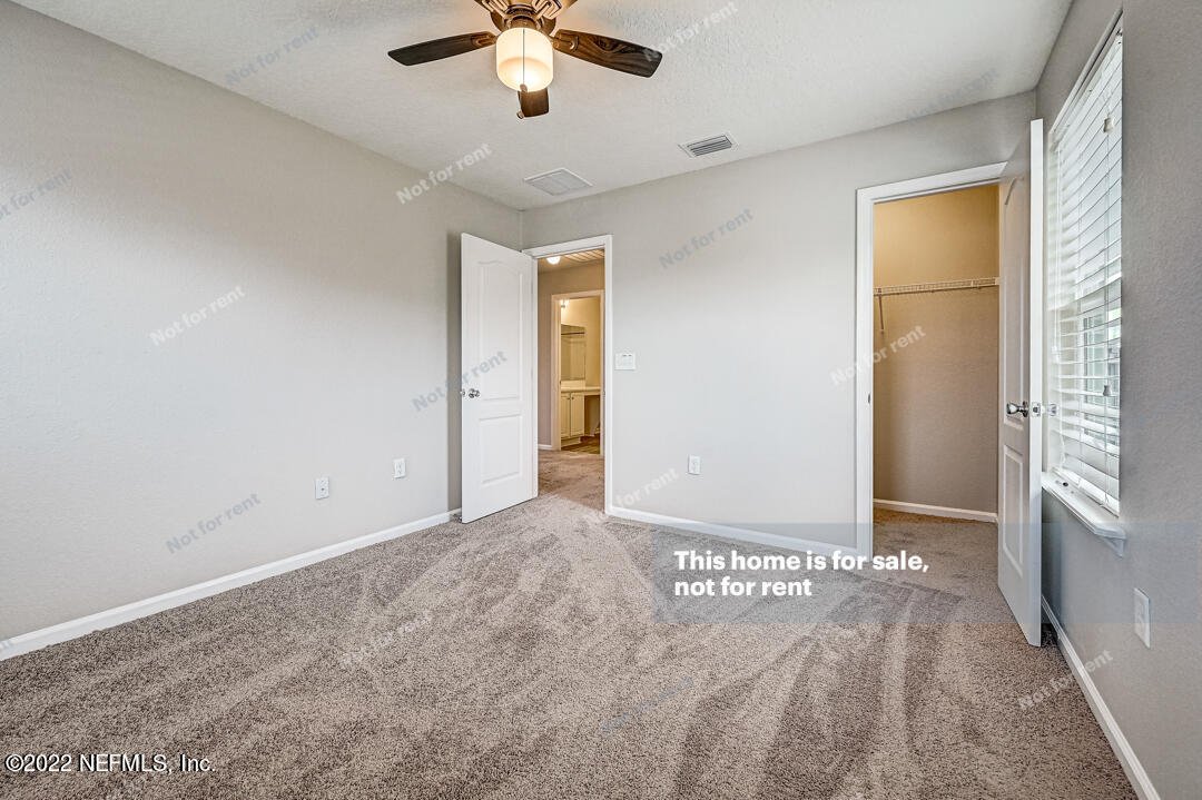 68 Redland Way Jacksonville, FL 32218 - Photo 25 of 36 an empty room with chandelier fan and windows