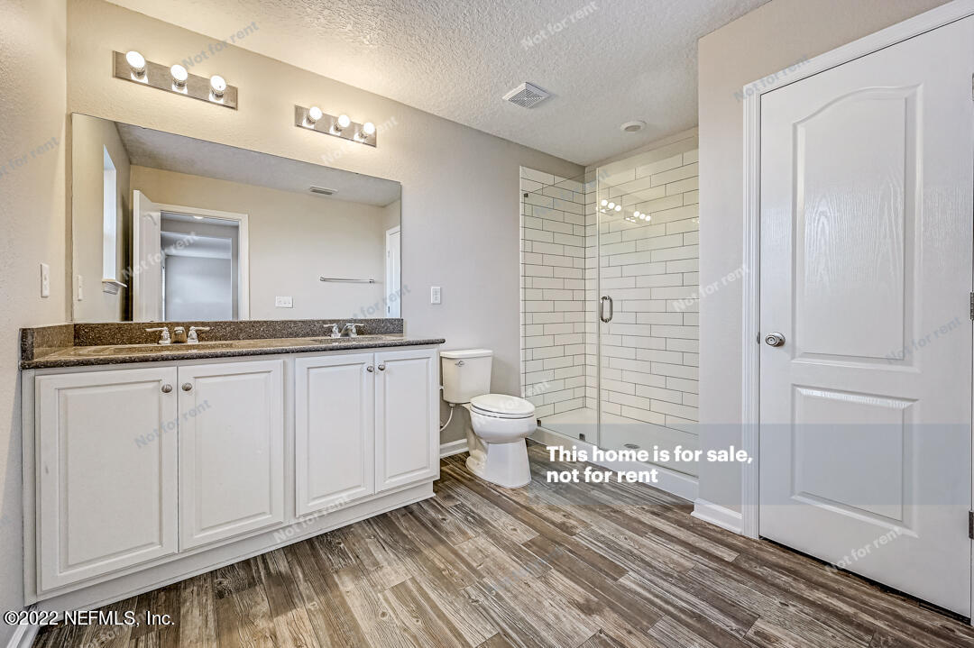 68 Redland Way Jacksonville, FL 32218 - Photo 29 of 36 a spacious bathroom with a granite countertop sink and a mirror