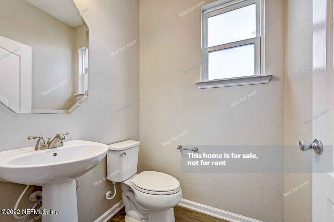 68 Redland Way Jacksonville, FL 32218 - Photo 31 of 36 a bathroom with a sink a mirror and a toilet