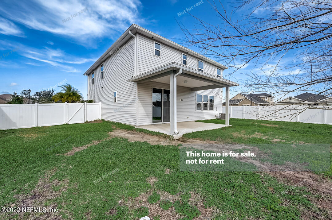 68 Redland Way Jacksonville, FL 32218 - Photo 34 of 36 a view of a white house with a big yard potted plants and large tree