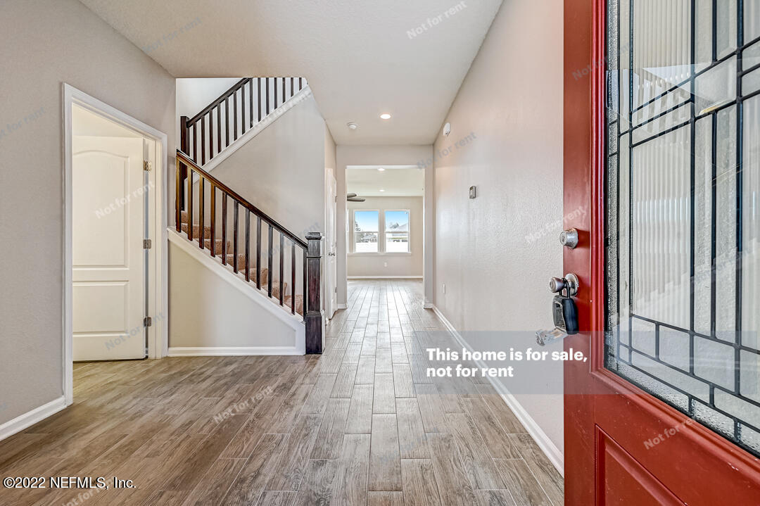 68 Redland Way Jacksonville, FL 32218 - Photo 4 of 36 a view of a hallway with wooden floor and entryway