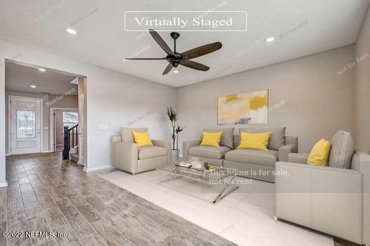 68 Redland Way Jacksonville, FL 32218 - Photo 5 of 36 a living room with furniture and a wooden floor