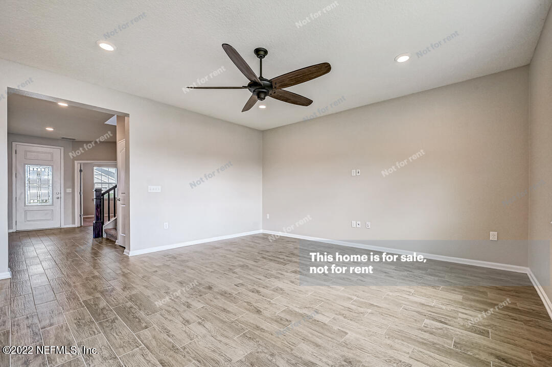 68 Redland Way Jacksonville, FL 32218 - Photo 6 of 36 a view of a livingroom with a ceiling fan & kitchen space