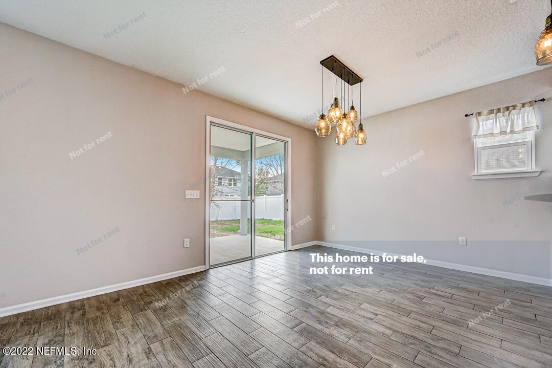 68 Redland Way Jacksonville, FL 32218 - Photo 8 of 36 wooden floor in an empty room with a window