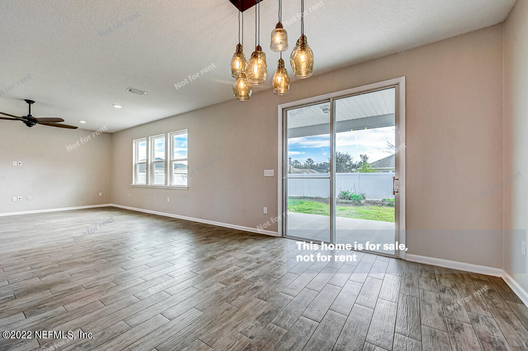 68 Redland Way Jacksonville, FL 32218 - Photo 9 of 36 a view of an empty room with wooden floor and a window