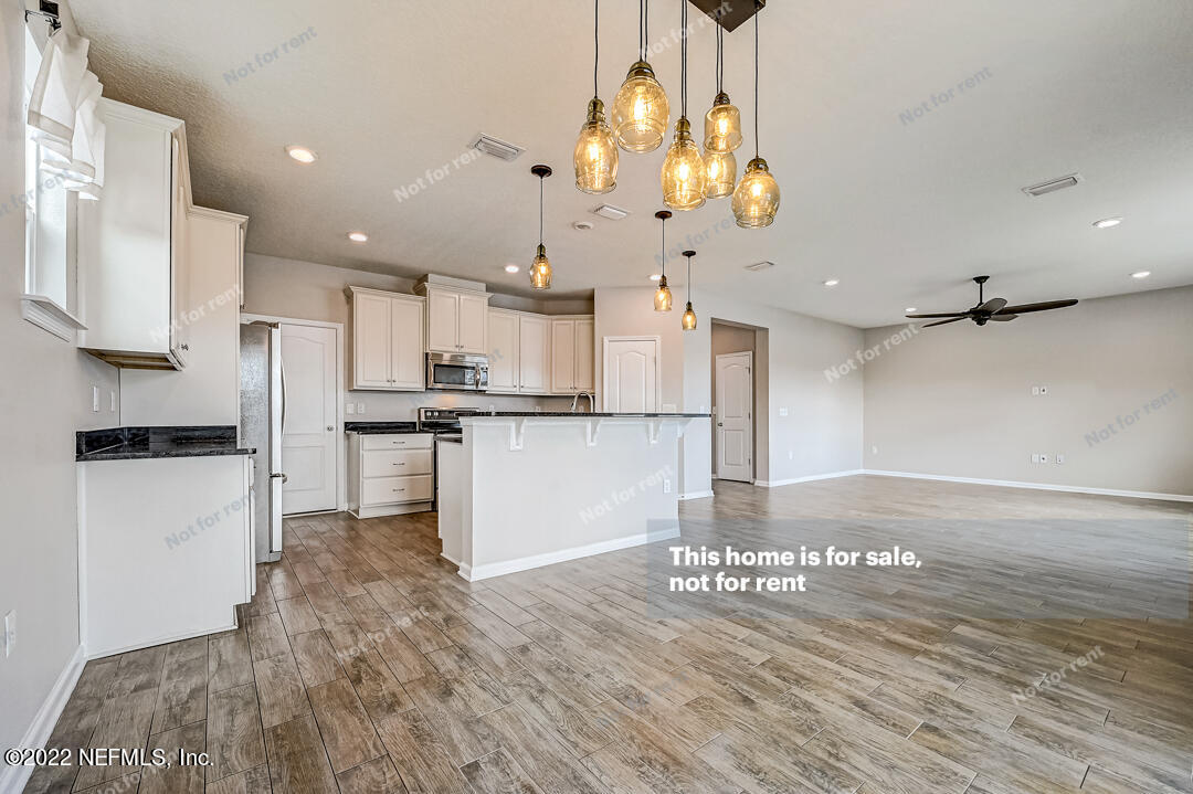 68 Redland Way Jacksonville, FL 32218 - Photo 10 of 36 a kitchen with stainless steel appliances kitchen island granite countertop a refrigerator and a stove top oven
