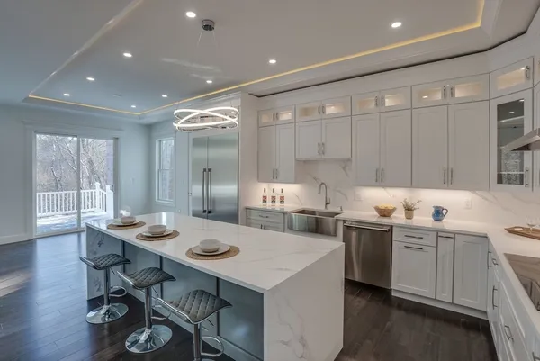 a kitchen with stainless steel appliances kitchen island granite countertop a sink and cabinets