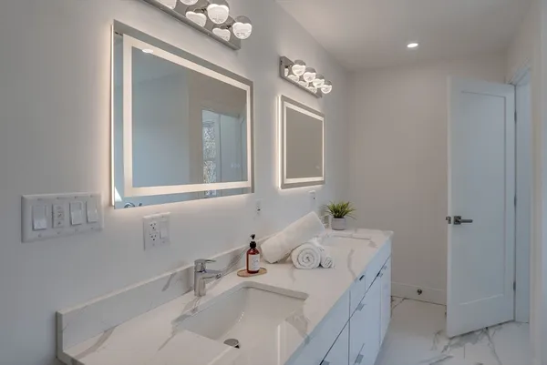 a bathroom with a sink vanity and a mirror