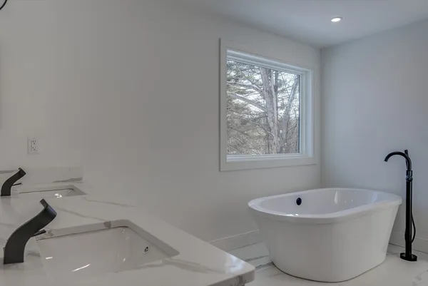 a bathroom with a bathtub and window