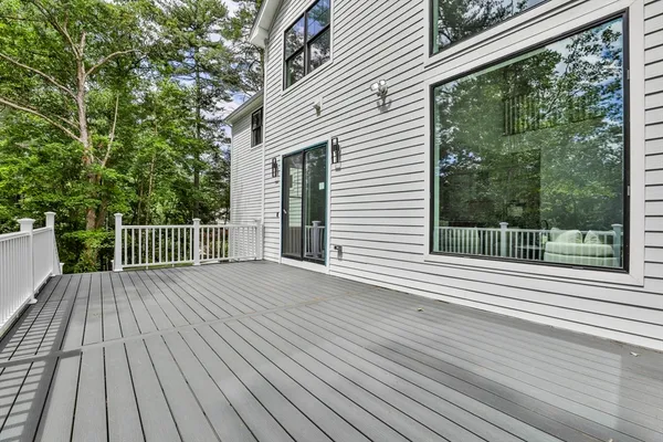 a view of a wooden deck with a yard