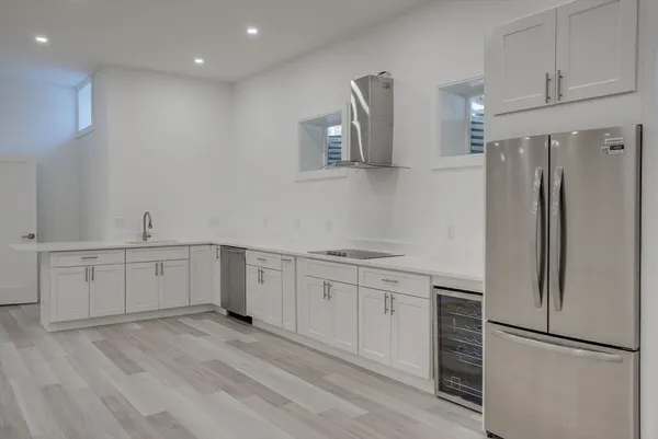 a kitchen with white cabinets and stainless steel appliances