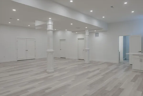a view of an empty room with wooden floor