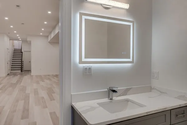 a bathroom with a sink a vanity and a mirror