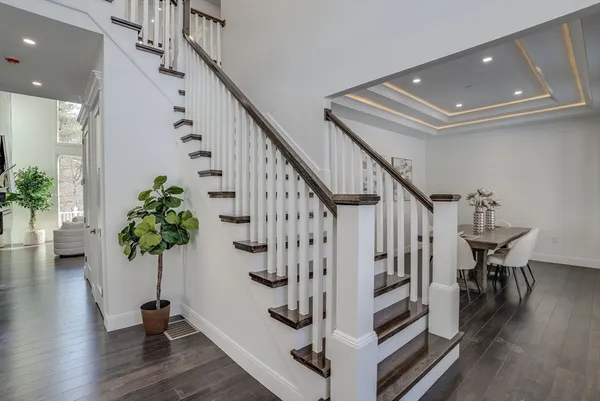 a view of entryway with wooden floor and stairs