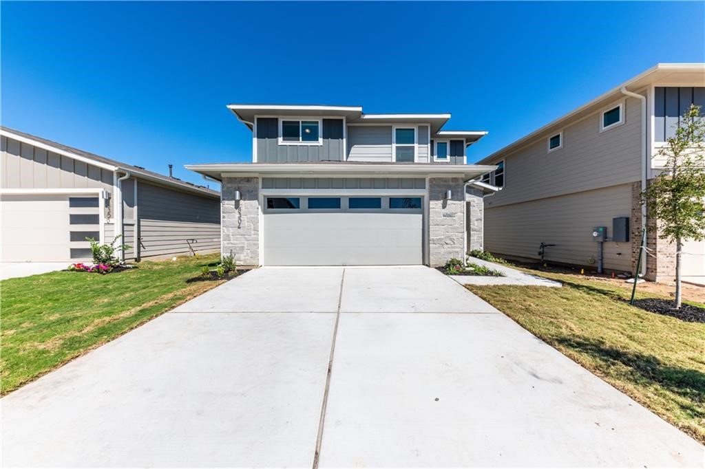 8304 Mimi Lane Austin, TX 78724 - Photo 1 of 32 a front view of a house with a yard and garage