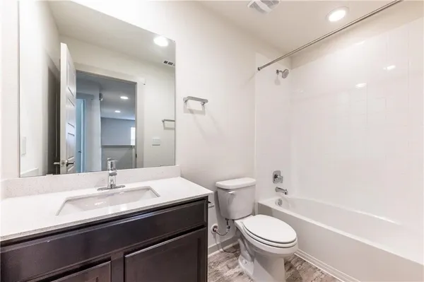 a spacious bathroom with a double vanity sink and mirror