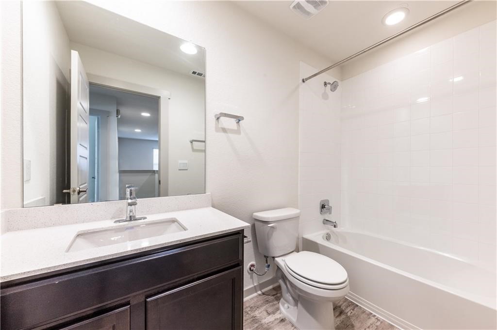 8304 Mimi Lane Austin, TX 78724 - Photo 16 of 32 a bathroom with a sink a toilet a mirror and shower