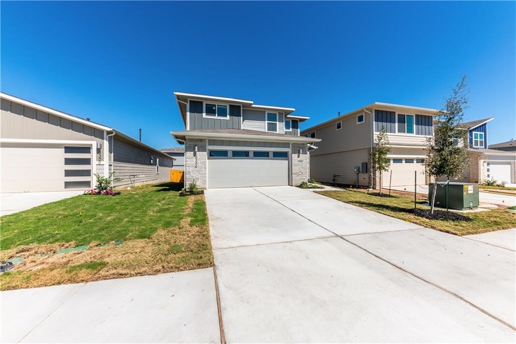 8304 Mimi Lane Austin, TX 78724 - Photo 2 of 32 a front view of a house with a yard and garage