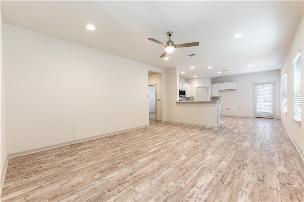 8304 Mimi Lane Austin, TX 78724 - Photo 4 of 32 a view of a kitchen with a sink and a refrigerator