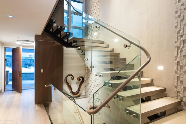 a spacious bathroom with a large mirror and a sink