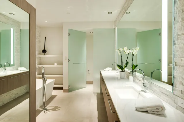 a view of walk in closet with wooden floor