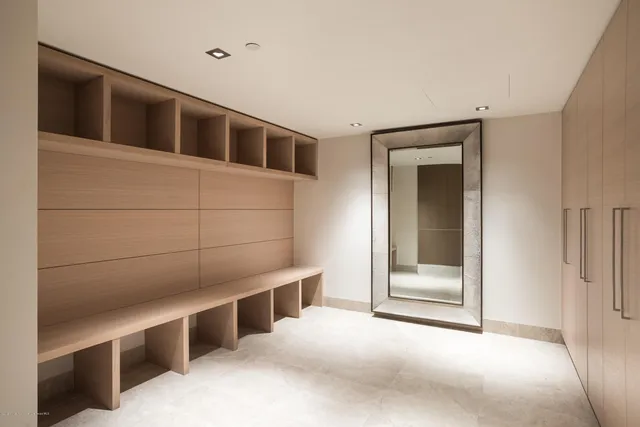 a bathroom with a granite countertop sink a toilet a mirror and shower