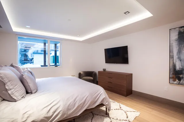 a bedroom with a large bed and a flat screen tv