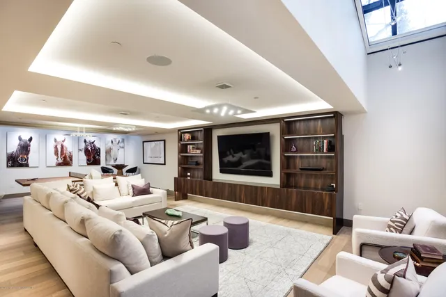 a living room with furniture and view of kitchen