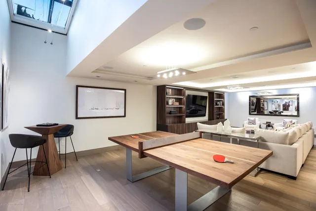 a living room with furniture a table and painting on the wall