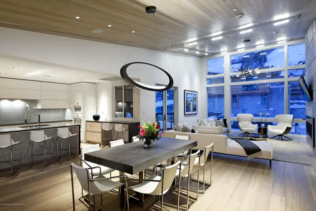 a view of a dining room with furniture wooden floor and chandelier