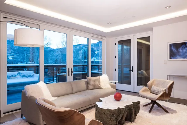 a living room with furniture and a mirror