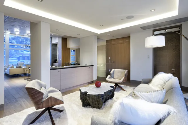 a living room with fireplace furniture and a chandelier