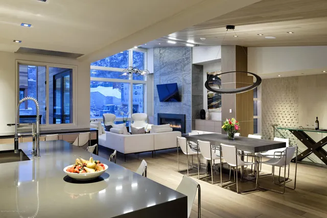 a kitchen with a sink a counter and chairs