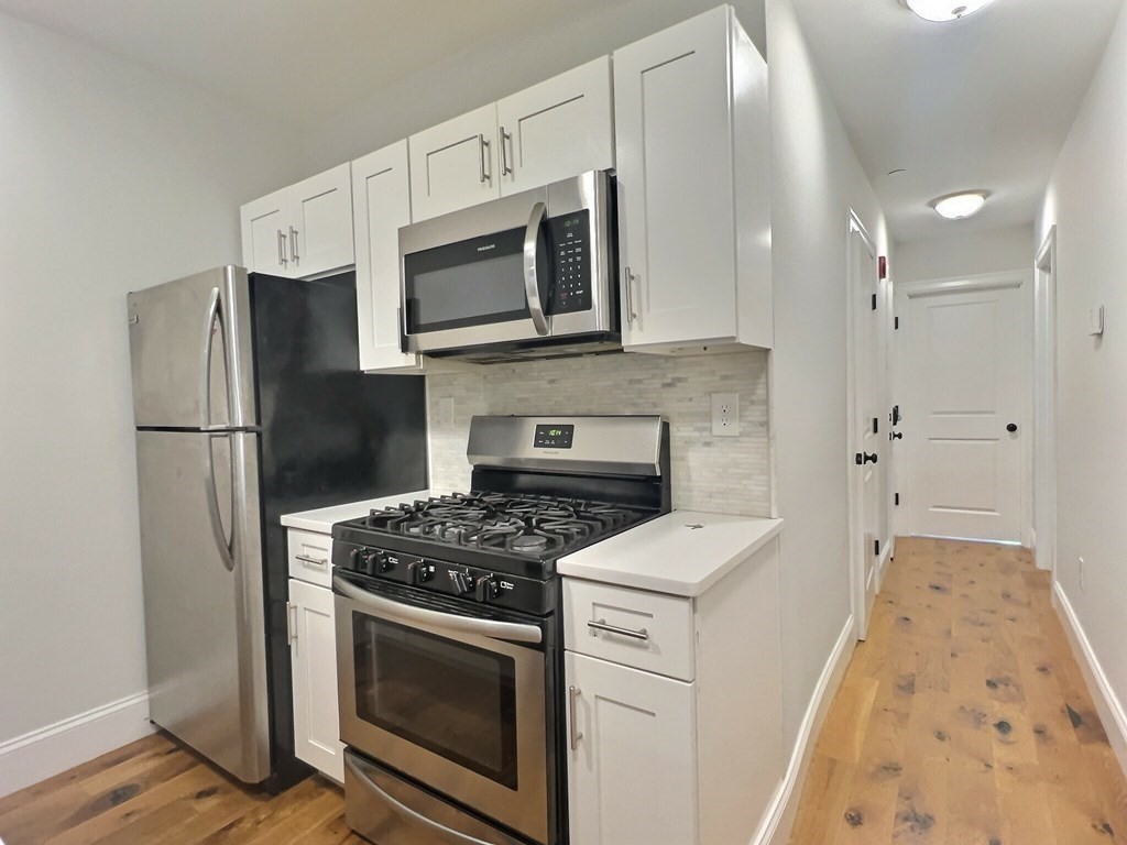 a kitchen with a stove microwave and refrigerator