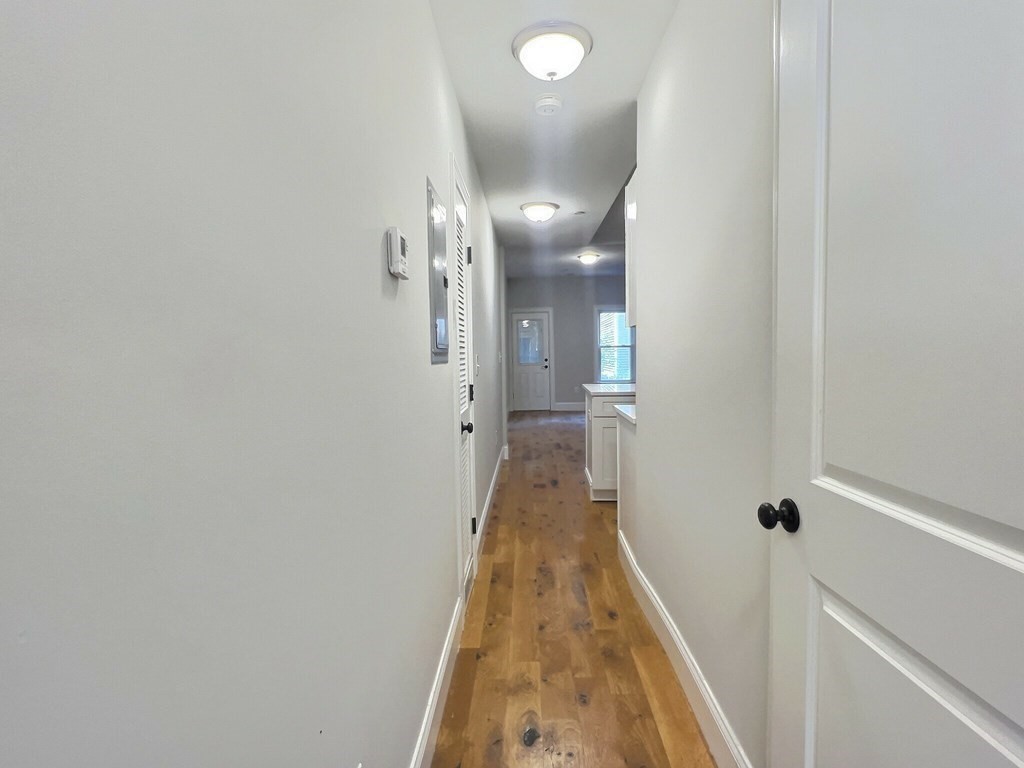 255 Paris Street, Unit 1 Boston, MA 02128 - Photo 11 of 15 a view of a hallway with a white walls