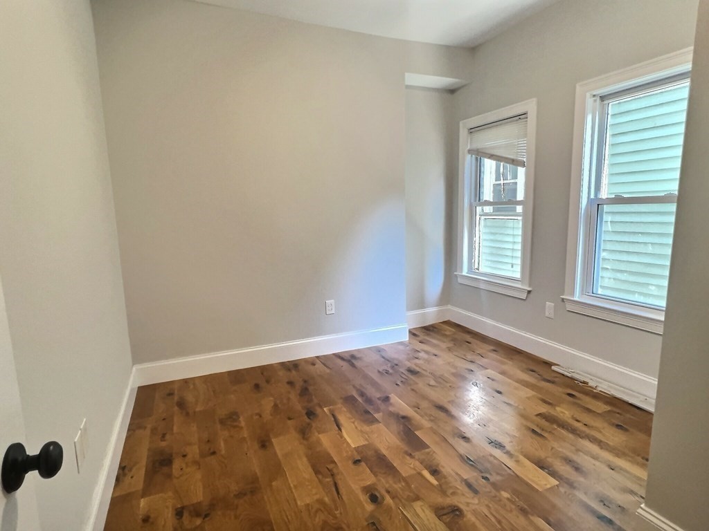 255 Paris Street, Unit 1 Boston, MA 02128 - Photo 12 of 15 a view of an empty room and window