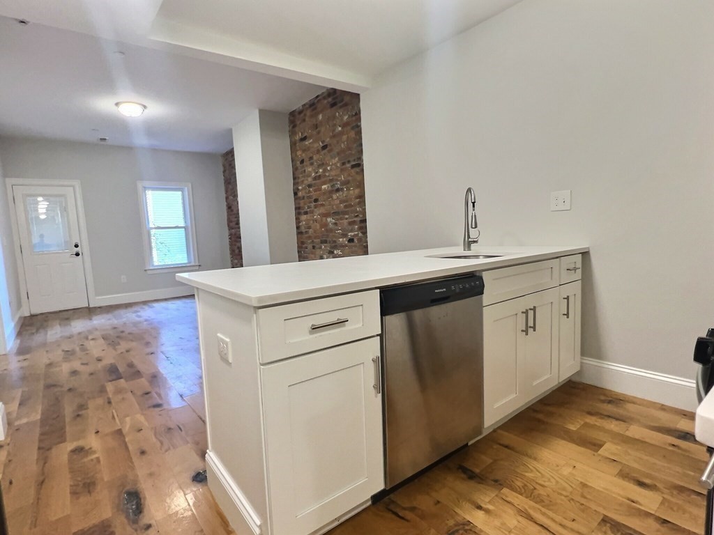 255 Paris Street, Unit 1 Boston, MA 02128 - Photo 2 of 15 a kitchen with a sink and cabinets