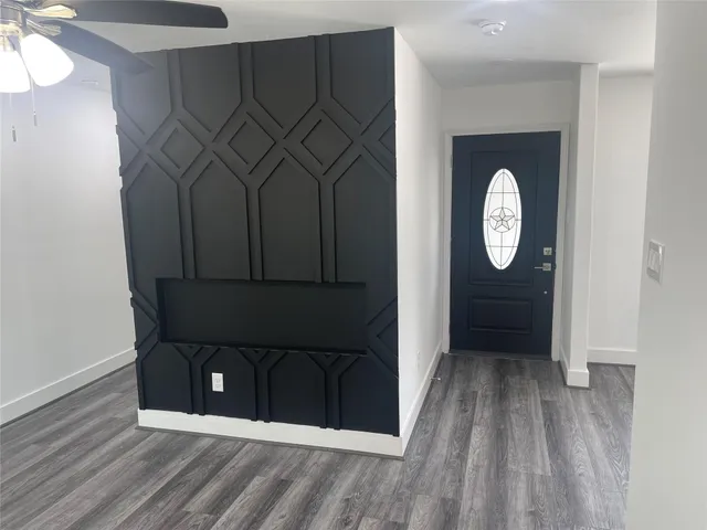 a kitchen with kitchen island granite countertop stainless steel appliances a sink stove and wooden floor