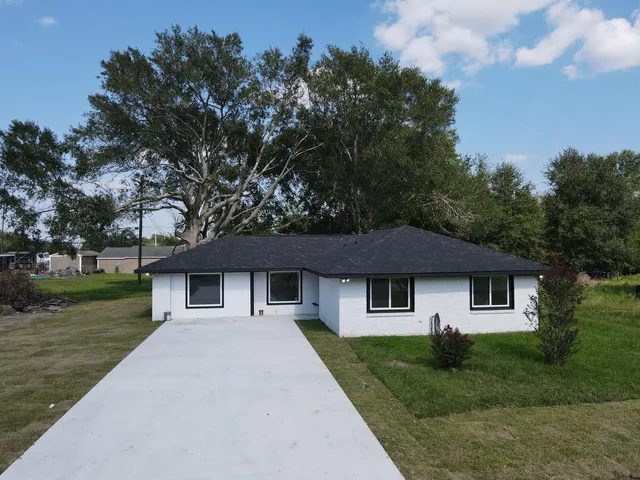 a kitchen with stainless steel appliances kitchen island a refrigerator sink and cabinets