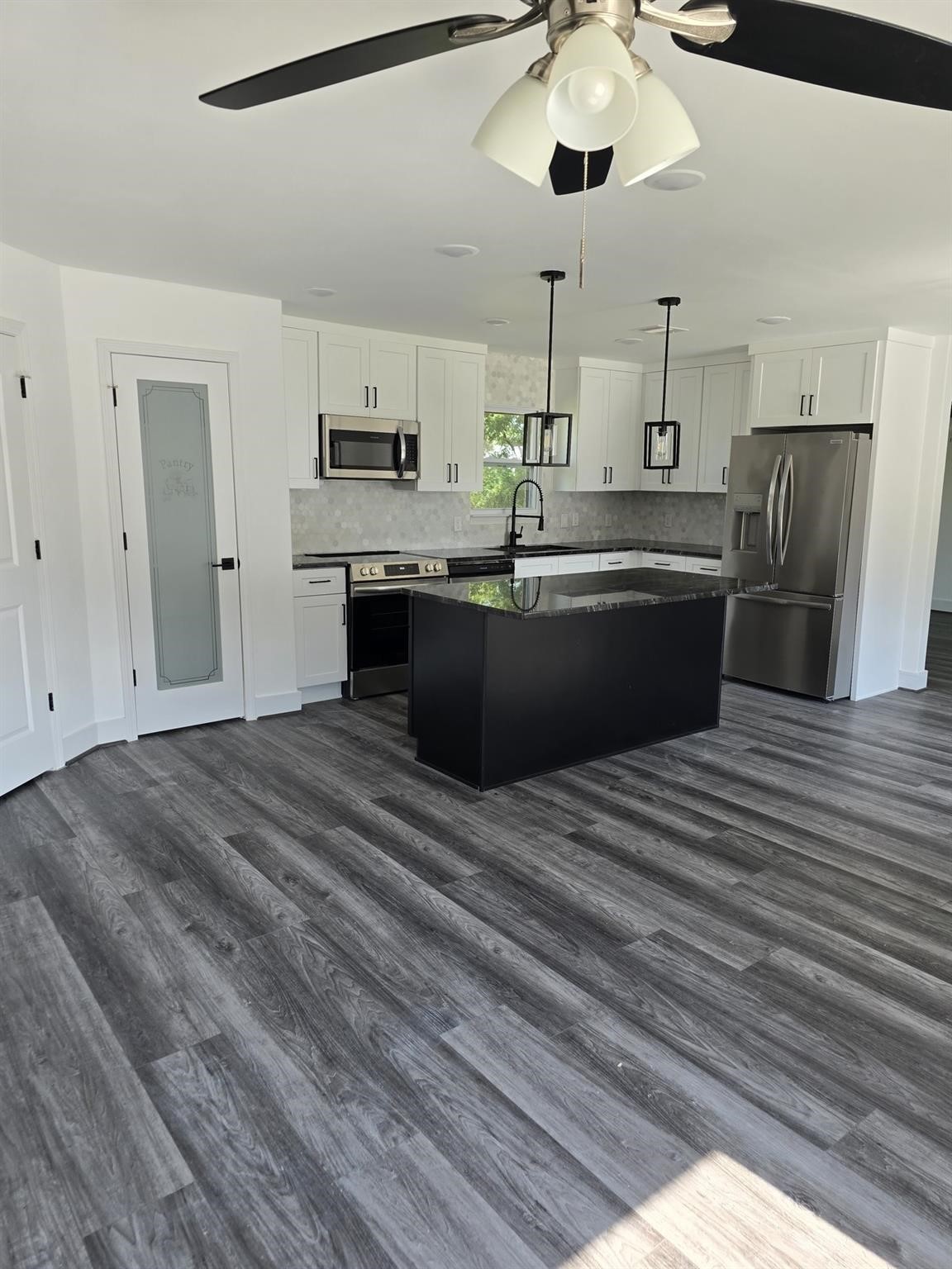 5821 Lantern Drive Beaumont, TX 77713 - Photo 9 of 17 a kitchen with stainless steel appliances kitchen island a refrigerator sink and cabinets